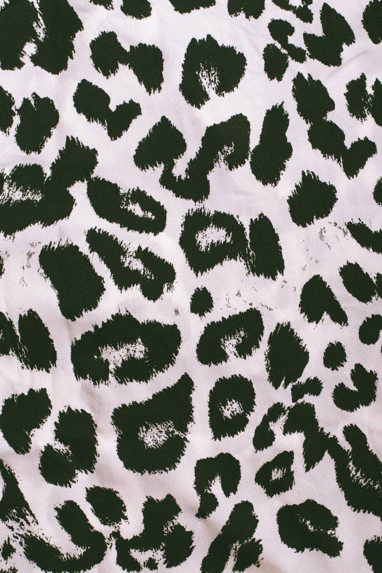 Close-up of a smooth leopard pattern fabric texture with ample copy space.