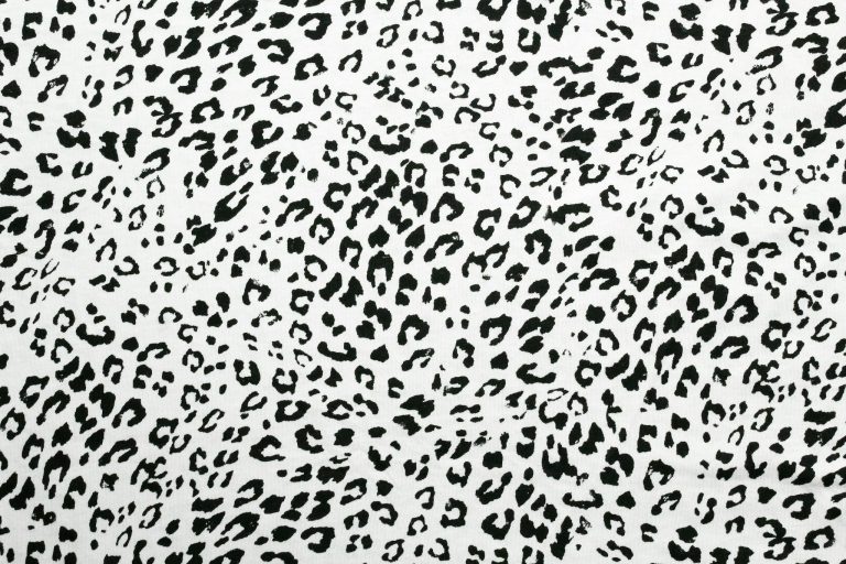 High-resolution image of black and white cheetah pattern fabric, ideal for textile design.
